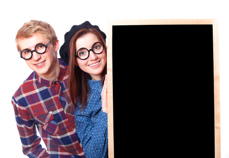 Nerd teen couple with blackboard.