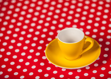Cup of a coffee on polka dot cover. Photo in old color image style.の写真素材