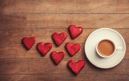 Cup of coffee and cookie on a wooden table.の写真素材