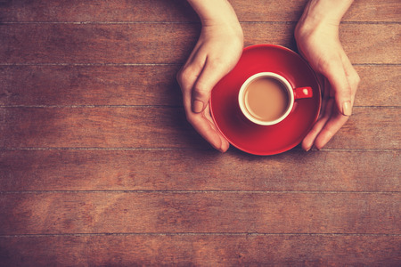 Female hands holding cup of coffee.の写真素材