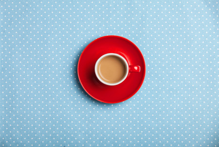 cup of coffee on speckled background.