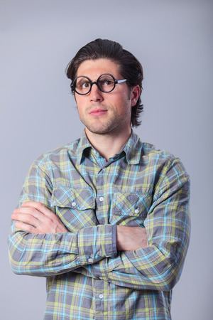 Portrait of funny man in glasses on gray background.の写真素材