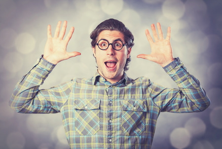 Portrait of funny man in glasses on gray background.の写真素材