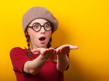 Redhead girl with pigtails on yellow background.の写真素材