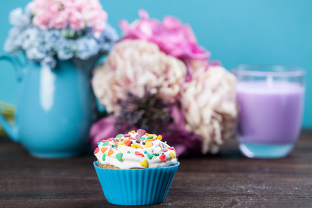 Cupcake and flowers on background.の写真素材