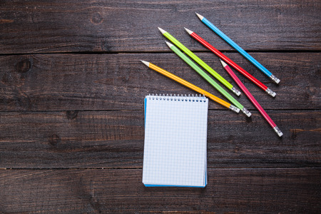 Pencils and notebook on wooden tableの写真素材