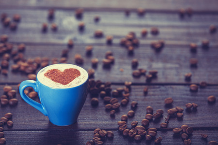 Cup of cÂoffee with shape heart on a wooden table.の写真素材