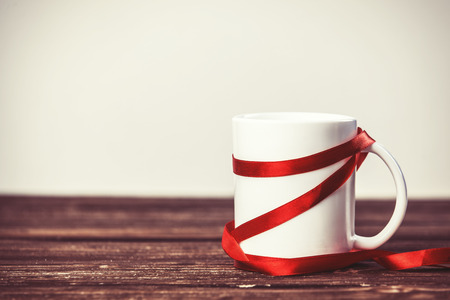 White cup on wooden table.の写真素材