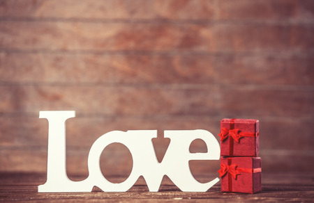 Little gift and word Love on wooden table.の写真素材