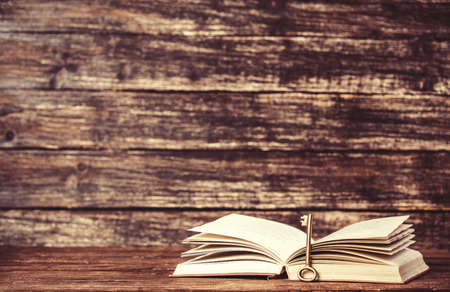 Vintage old books on wooden tableの写真素材