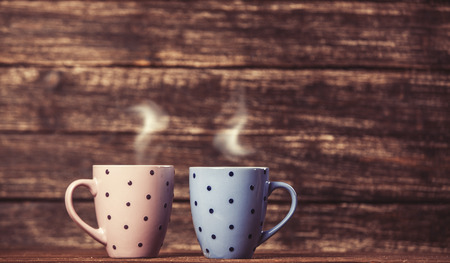 Two tea or coffee cup on wooden table.の写真素材