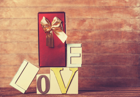 Little gift and word Love on wooden table.の写真素材