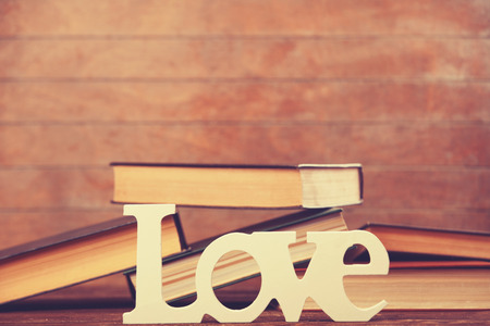 Word love and books on wooden table.の写真素材