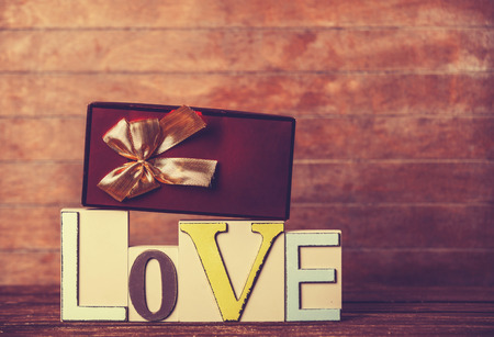 Little gift and word Love on wooden table.の写真素材
