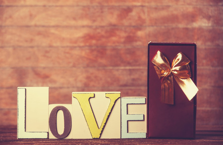 Little gift and word Love on wooden table.の写真素材