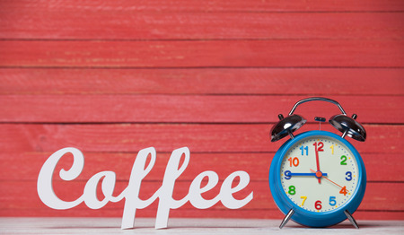 Alarm clock and wooden word Coffee.の写真素材