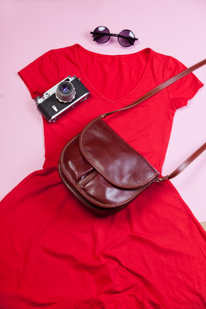 Camera, bag, dress and sunglasses on pink background.の写真素材