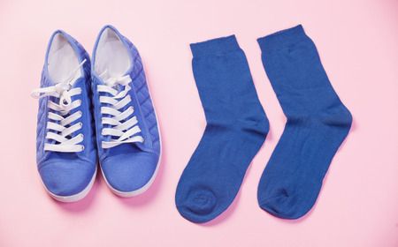 Gumshoes and socks in pink background.の写真素材
