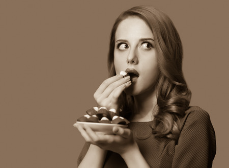 Women with candy. Photo in sepia color image style.の写真素材