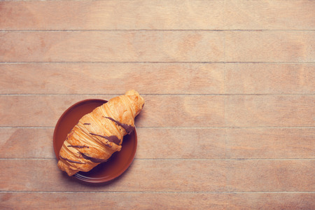 french croissant on a wooden tableの写真素材
