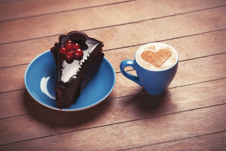 Cake and cup of coffee on a wooden table.の写真素材