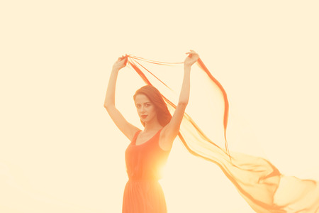 Women with fabric on sunset.の写真素材