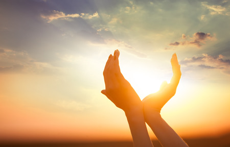 hands holding the sun at dawn hands holding the sun at dawn