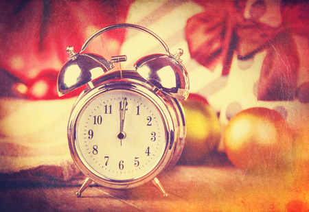 Vintage clock on christmas background. Photo in retro color image style.の写真素材
