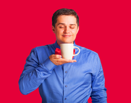 Happy man in shirt with cup of coffee の写真素材
