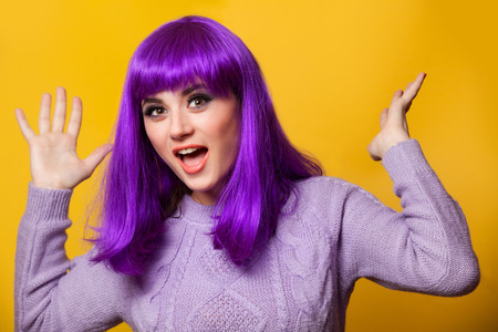 Happy girl with violet hair on violet background.の写真素材