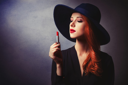 Style redhead women in black wth lipstick on classic backgroundの写真素材