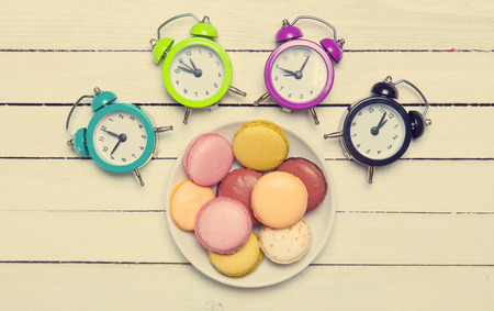Clock and macaron with christmas toys.の写真素材