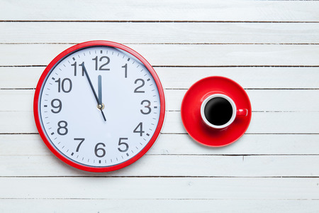 Redh clock and cup on white background.の写真素材