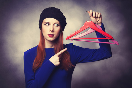 Portrait of beautiful women in blue dress with hanger and bokeh on background.の写真素材
