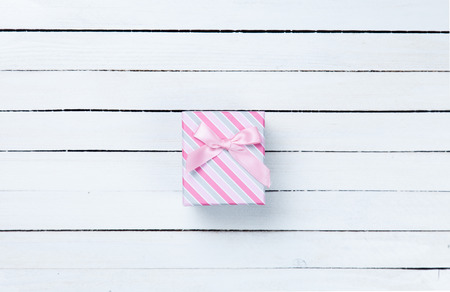 Beautiful gift box presents on white wooden background