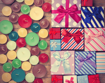 Gift boxes with candles on wooden backgroundの写真素材