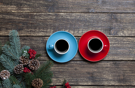 Two cups of coffee and branch on a wooden table.の写真素材