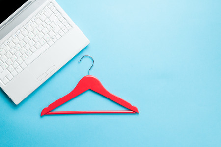 White computer and hanger on blue backgroundの写真素材