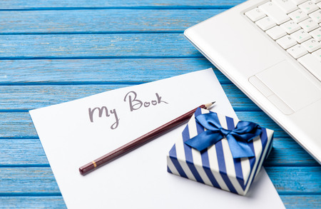 pencil and paper with My Book inscription near notebook on blue wooden tableの写真素材
