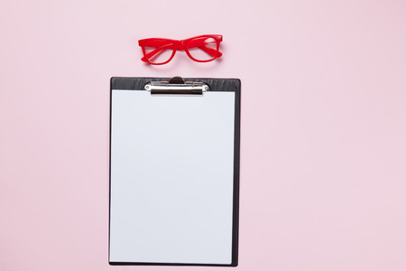 Glasses and business board on pink backgroundの写真素材