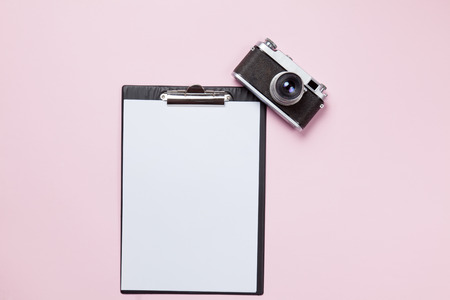 Classic camera and business board on pink background.の写真素材
