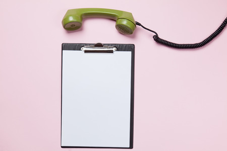 dial phone and business board on pink backgroundの写真素材