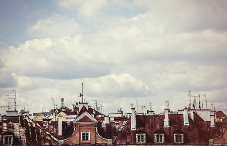 Old roofs and sky with clouds on background.の写真素材