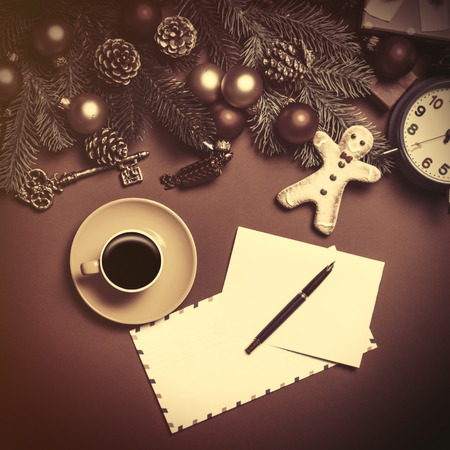 Coffee and letter with christmas gifts on red background.の写真素材