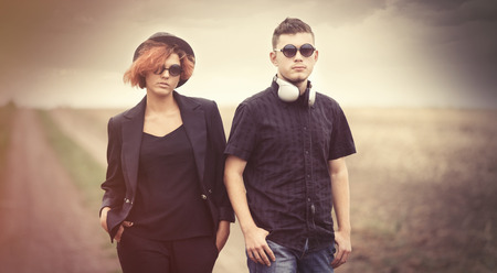 Style young couple at countryside outdoor. Photo in old color image style.の写真素材