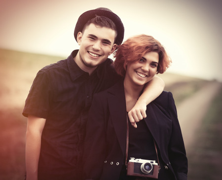 Style young couple at countryside outdoor. Photo in old color image style.の写真素材