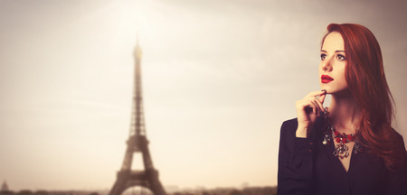 Portrait of a style redhead women on Eiffel tower background.の写真素材