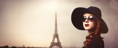 Style redhead women with sunglasses on Eiffel tower backgroundの写真素材