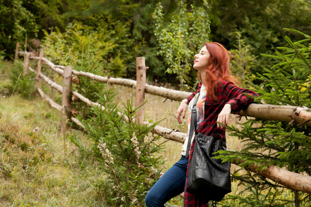 Portrait of a redhead woomen in tartan clothes at outdoorの写真素材