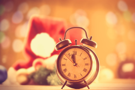 Vintage alarm clock on yellow Christmas backgroundの写真素材